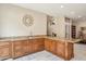 Charming bar area with granite countertops, wood cabinets, and views to other levels at 5523 W Creekside Ln, San Tan Valley, AZ 85144