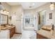 Bathroom features double vanities, granite countertops, arched windows over a large soaking tub and walk-in shower at 5523 W Creekside Ln, San Tan Valley, AZ 85144