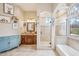 Elegant bathroom featuring stone countertops, soaking tub, and a separate shower with refined finishes for a luxurious experience at 5523 W Creekside Ln, San Tan Valley, AZ 85144