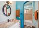 The bathroom has a modern sink, and neutral paint contrasted against a bold, blue wall at 5523 W Creekside Ln, San Tan Valley, AZ 85144