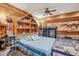 Cozy bedroom with wood-paneled walls and playful decor at 5523 W Creekside Ln, San Tan Valley, AZ 85144