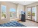 Bright bedroom with large windows and a door to patio offering plenty of natural light and outdoor access at 5523 W Creekside Ln, San Tan Valley, AZ 85144