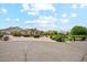 Beautiful home features a circular driveway, lush landscaping, and mountain views at 5523 W Creekside Ln, San Tan Valley, AZ 85144