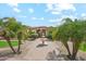 Elegant home entrance featuring a tiered fountain and lush tropical landscaping at 5523 W Creekside Ln, San Tan Valley, AZ 85144