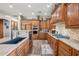 Well-appointed kitchen with custom wood cabinets, granite countertops, stainless steel appliances, and a breakfast bar at 5523 W Creekside Ln, San Tan Valley, AZ 85144