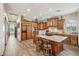 Gourmet kitchen features wood cabinets, an island with seating, and modern appliances at 5523 W Creekside Ln, San Tan Valley, AZ 85144