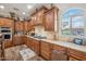 Kitchen featuring custom wood cabinets, granite countertops, and tile backsplash at 5523 W Creekside Ln, San Tan Valley, AZ 85144