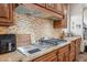 This kitchen features stainless appliances, wood cabinets, and granite counters at 5523 W Creekside Ln, San Tan Valley, AZ 85144