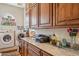 Laundry room features granite counters, wood cabinets, and a large window at 5523 W Creekside Ln, San Tan Valley, AZ 85144