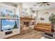 Living room featuring a beautiful stone fireplace and a ceiling fan at 5523 W Creekside Ln, San Tan Valley, AZ 85144