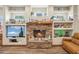 Inviting living room with a stone fireplace and built-in shelving for decor at 5523 W Creekside Ln, San Tan Valley, AZ 85144