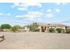 Single-story home with stucco exterior, gravel landscaping, covered patio, and mature trees and plants at 5523 W Creekside Ln, San Tan Valley, AZ 85144