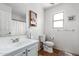 Bright bathroom with a white sink, toilet, mirror, and a window view at 559 W Viola St, Casa Grande, AZ 85122