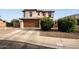 Exterior front view of home with a concrete driveway and desert landscaping at 559 W Viola St, Casa Grande, AZ 85122