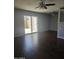 Bright living room with sliding glass doors, wood-look flooring, and ceiling fan at 600 S Dobson Rd # 53, Mesa, AZ 85202