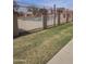 View of the community pool featuring decorative wrought iron fencing and grass at 600 S Dobson Rd # 53, Mesa, AZ 85202
