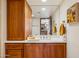 Bathroom with double sinks and vanity with wood cabinets, a mirror, and a view of the kitchen at 6122 E Harvard St, Scottsdale, AZ 85257