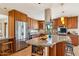 Modern kitchen equipped with stainless steel appliances, granite countertops, and a large center island at 6122 E Harvard St, Scottsdale, AZ 85257