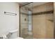 Bathroom with tiled walk-in shower featuring a glass door and fixtures at 6122 E Harvard St, Scottsdale, AZ 85257
