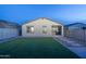 Spacious backyard featuring an artificial lawn and a cozy, covered patio at 6732 W Pedro Ln, Laveen, AZ 85339