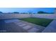 Private backyard features a cozy lawn with an adjacent area of paving stones at 6732 W Pedro Ln, Laveen, AZ 85339