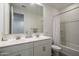 Bright bathroom featuring a double vanity, toilet, and shower with tub at 6732 W Pedro Ln, Laveen, AZ 85339