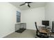 Minimal bedroom featuring large window, ceiling fan, and desk setup at 6732 W Pedro Ln, Laveen, AZ 85339
