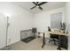 Bright bedroom featuring a ceiling fan, desk and a pet kennel at 6732 W Pedro Ln, Laveen, AZ 85339