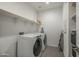 The laundry room has modern appliances and ample shelving for storage at 6732 W Pedro Ln, Laveen, AZ 85339
