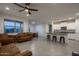 Open living space with tile floors and a view into the kitchen with bar stool seating at 6732 W Pedro Ln, Laveen, AZ 85339