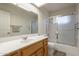 Bathroom featuring a tiled shower and tub combo and vanity at 7925 E Monte Ave, Mesa, AZ 85209