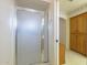Bathroom with frosted glass shower enclosure and wooden vanity with upper cabinets at 7925 E Monte Ave, Mesa, AZ 85209