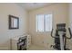 Bedroom featuring a desk and chair, mirror, exercise bike, and window at 7925 E Monte Ave, Mesa, AZ 85209