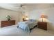 Spacious bedroom with comfortable bed, floral decor, and two bedside tables with lamps at 7925 E Monte Ave, Mesa, AZ 85209