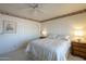 Bedroom with neutral tones, light walls and carpet, complemented by wooden nightstands at 7925 E Monte Ave, Mesa, AZ 85209