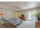 Comfortable bedroom with neutral carpet, ceiling fan and sliding door to the outside patio at 7925 E Monte Ave, Mesa, AZ 85209