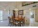 Dining room features a wooden table with seating for six, overhead lighting, and built-in shelving at 7925 E Monte Ave, Mesa, AZ 85209