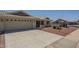 Desert home with front yard cactus garden, tile roof, and wide two car garage at 7925 E Monte Ave, Mesa, AZ 85209
