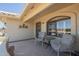 Inviting front porch with seating area, decorative welcome sign, and security door at 7925 E Monte Ave, Mesa, AZ 85209