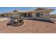 Inviting home featuring desert landscaping, beige stucco exterior, and covered front porch at 7925 E Monte Ave, Mesa, AZ 85209