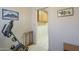 Hallway with exercise equipment, paintings, doorway, and tiled floor at 7925 E Monte Ave, Mesa, AZ 85209