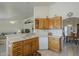 Eat in kitchen with white countertops and oak cabinets, seamless entertaining and daily life at 7925 E Monte Ave, Mesa, AZ 85209