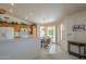 Bright eat-in kitchen with wood cabinets, white appliances, breakfast nook, and easy access to outdoor living at 7925 E Monte Ave, Mesa, AZ 85209