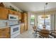 Well-appointed kitchen with breakfast nook, light-filled windows and updated appliances at 7925 E Monte Ave, Mesa, AZ 85209