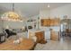 Open kitchen overlooking the living room with wood cabinets and white appliances, perfect for entertaining at 7925 E Monte Ave, Mesa, AZ 85209