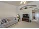 The spacious living room features neutral colors, a ceiling fan, and a decorative ledge perfect for displaying decor at 7925 E Monte Ave, Mesa, AZ 85209