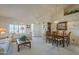 Bright, open-concept living and dining area featuring carpeted floors and vaulted ceilings at 7925 E Monte Ave, Mesa, AZ 85209