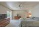 Comfortable carpeted bedroom with light walls, ceiling fan, and sliding glass door to the outside at 7925 E Monte Ave, Mesa, AZ 85209