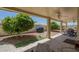 Covered patio with ceiling fans, tiled flooring, grill, mature landscaping, and patio furniture at 7925 E Monte Ave, Mesa, AZ 85209