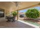 Inviting covered patio with ceiling fan, outdoor dining area, and well-manicured landscaping offers great outdoor living at 7925 E Monte Ave, Mesa, AZ 85209